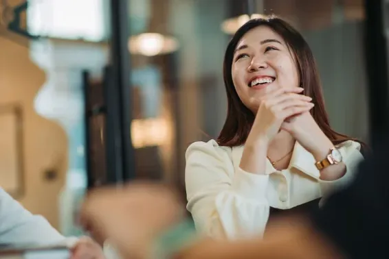 Actuary sitting at desk and smiling.