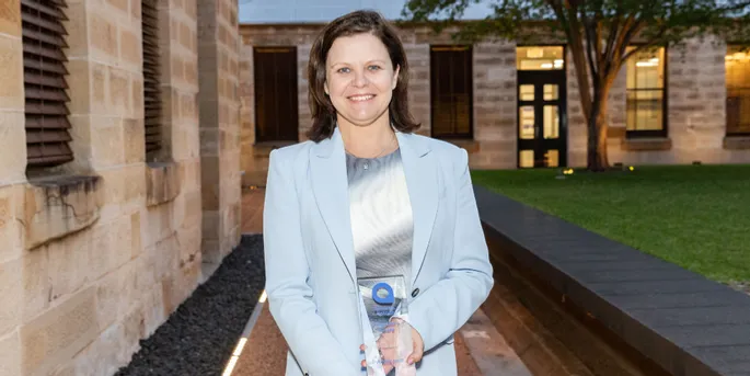 Photo of the 2024 Presidents Award winner for the Volunteer of the Year, smiling in blue jacket