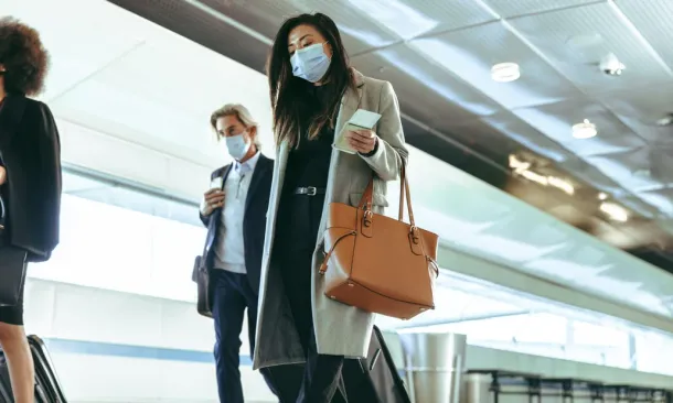 People travelling during Covid, with masks on 