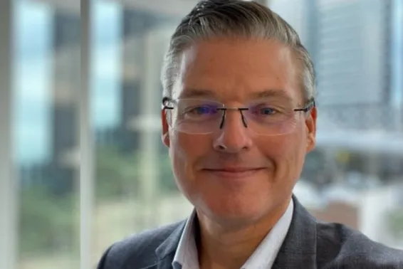 Male head shot smiling and looking at camera in business suit
