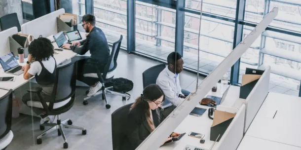 A high shot of office workers, working in an office.