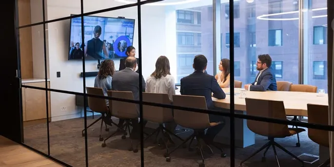 Group of actuaries sitting in a boardroom listening to an actuary present