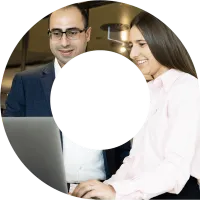 Man and a woman typing on a laptop smiling