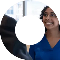 A young woman in blue shirt smiling within a viewfinder shape