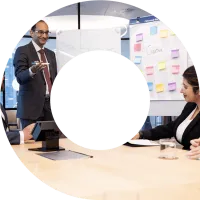 Viewfinder containing image of actuaries brainstorming around a whiteboard in a meeting room