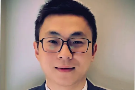 Portrait photo of male, smiling and looking at camera, with short black hair