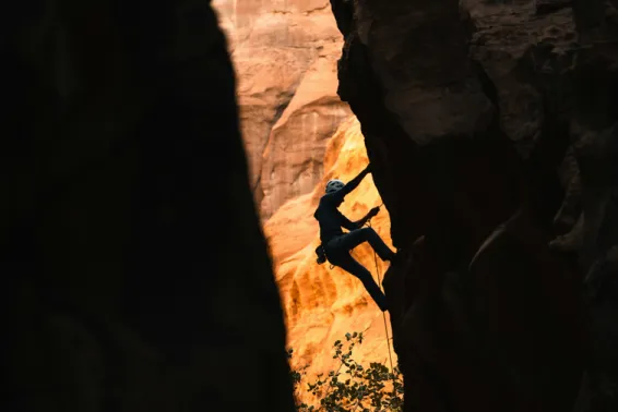 Undefined person rock-climbing in a narrow pass.  