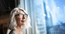 Mature businesswoman looking out of window.