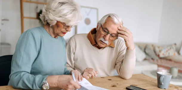 Senior couple going over bills in a domestic room