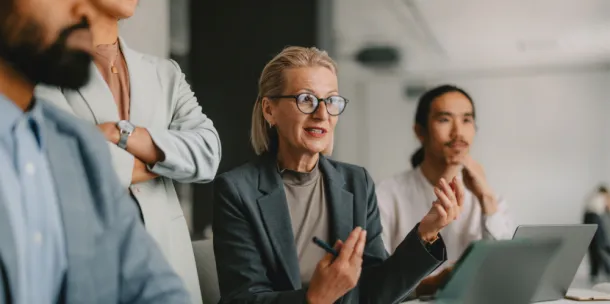 A diverse group of professional individuals engaged in a business meeting.