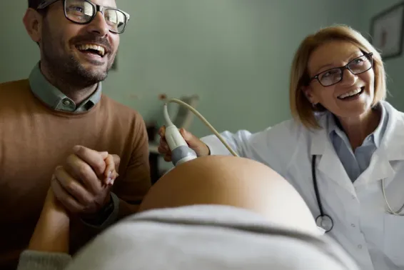 Man and pregnant woman at trimester scan 