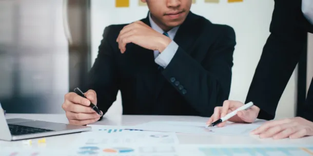 Business discussion between two people showing each other some documents