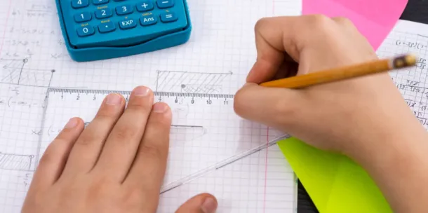 Someone drawing a triangle of some sort using a set square ruler