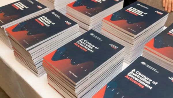 Stacked books. Title of stacked books is "A century of Australian government actuaries"