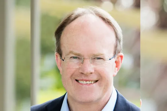 Business man with glasses smiling and looking at camera, portrait shot