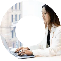 Young woman wearing white suit jacket typing on laptop in viewfinder shape