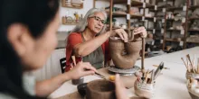 Senior woman making a craft product on a ceramics workshop