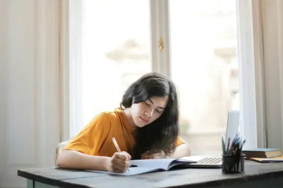 Woman sitting at a table taking a past exam