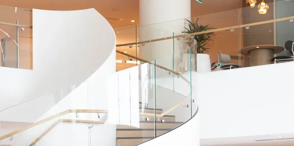 The top of a white and timber staircase.