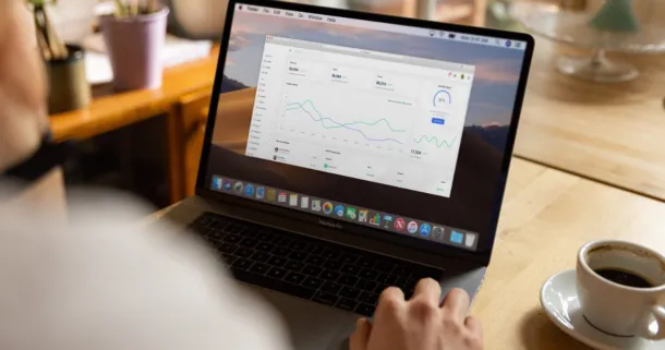 A close-up of a person on their laptop, checking stock.