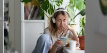 Women listening to podcast at home