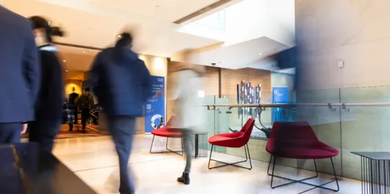 Blurred image of people walking in corridor.