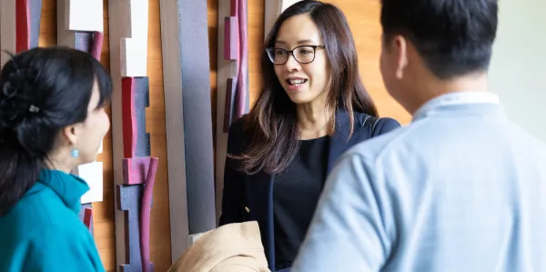 Group of male and female business people talking.