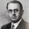 A black and white photo of a professional man wearing glasses.