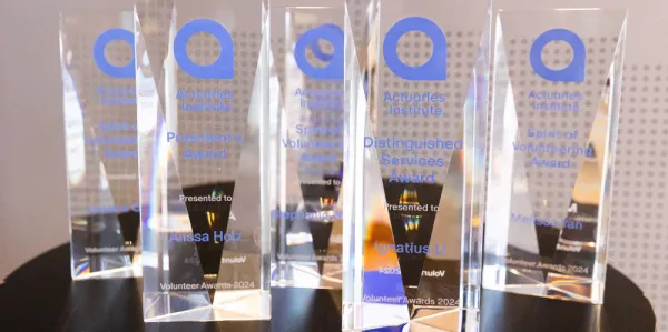 Glass trophies on a desk with company logo