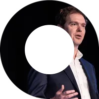 Actuary speaking on stage at an event in a viewfinder shape