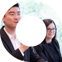 A man and a woman at a conference event within a viewfinder shape