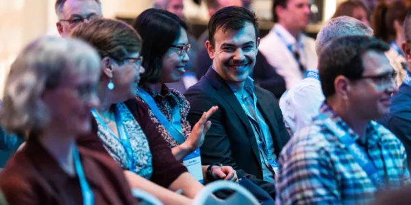 Men and women sitting in a audience at a conference - What's On at the Actuaries Institute.
