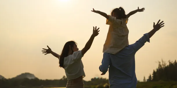 Family enjoying a sunset in a field
