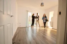 Young couple viewing a house with a real-estate agent.