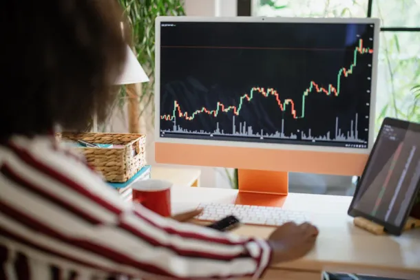 Entrepreneur analysing a cryptocurrency market graph at home office