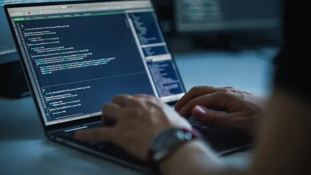Close-up Focus on Person's Hands Typing on the Desktop Computer Keyboard. Screens Show Coding Language User Interface. Software Engineer Create Innovative e-Commerce App. Program Development
