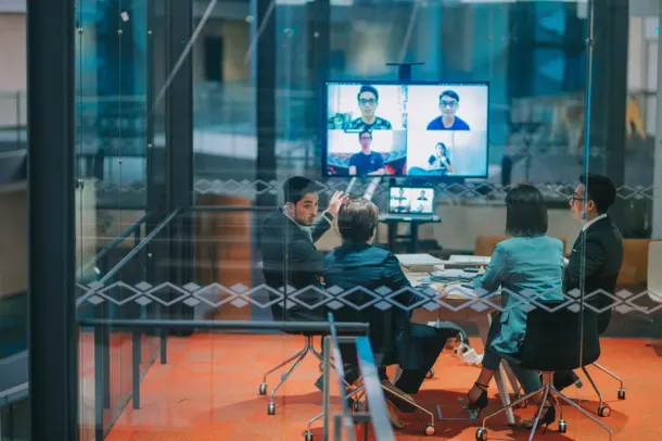 Asian Chinese colleague videocall meeting discussion in transparent meeting room