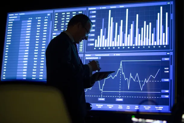 Side view of financial specialist checking data. Joyful man in formalwear making financial report and forecast, calculating and analyzing stock market data.Financial analytics, business growth concept