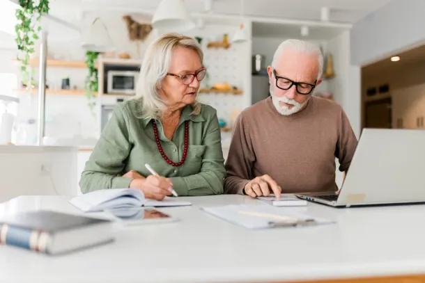 Couple using laptop while planning their home budget