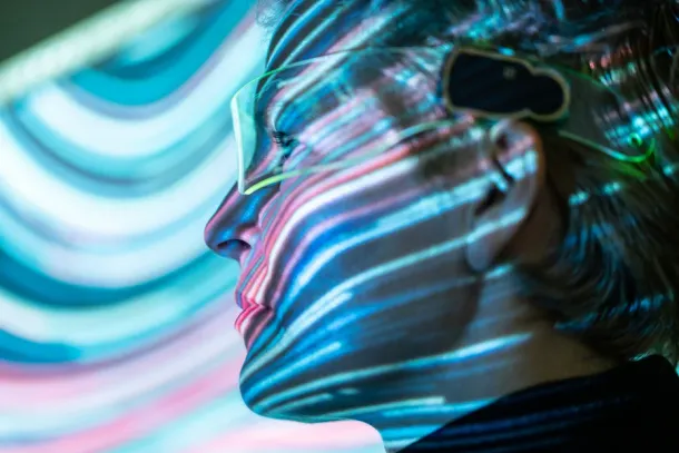Colorful streaks of light placed across a woman's face's features